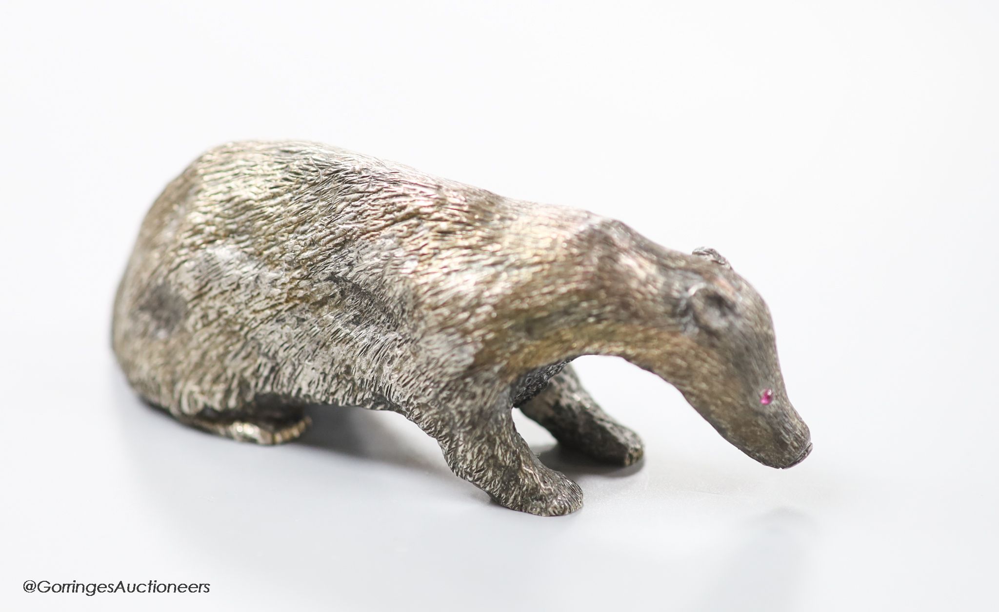 A modern free standing miniature model of a badger, with cabochon eyes, C.F.H & Co, London, 1992, length 10cm, 142 grams.